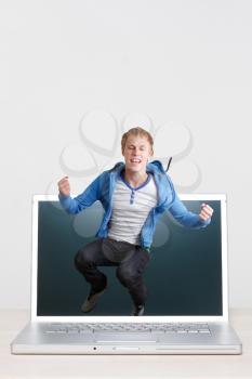 Royalty Free Photo of a Teenager Jumping Out of a Computer