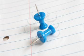 Royalty Free Photo of Pushpins on Paper
