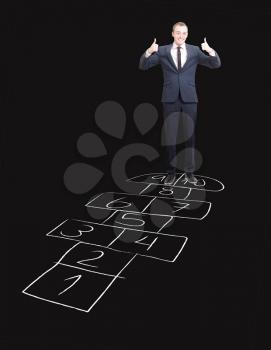 Royalty Free Photo of a Businessman Playing Hopscotch