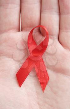 Royalty Free Photo of a Person Holding a Red Ribbon