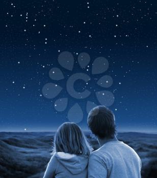 Royalty Free Photo of a Couple Looking at a Starry Sky