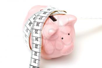 Royalty Free Photo of a Piggy Bank With Measuring Tape