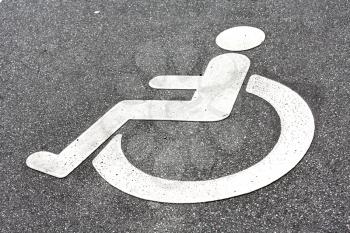 Royalty Free Photo of a Disability Logo on the Road