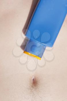 Royalty Free Photo of Sunscreen on a Man's Stomach