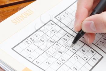 Royalty Free Photo of a Person Solving a Sudoku Puzzle