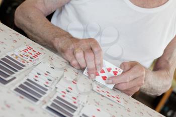 Royalty Free Photo of an Old Man Playing Solitaire
