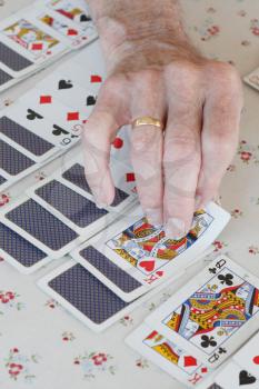 Royalty Free Photo of an Old Man Playing Solitaire