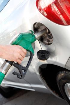 Royalty Free Photo of a Person Putting Gas Into a Car