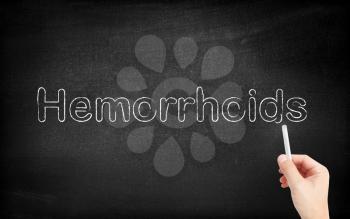 Hemorrhoids written on white blackboard