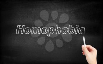 Homophobia written on white blackboard