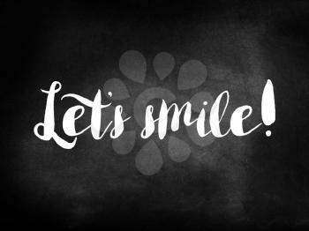 Let's smile written on a chalkboard