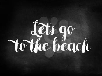 Let’s go to the beach written on a blackboard