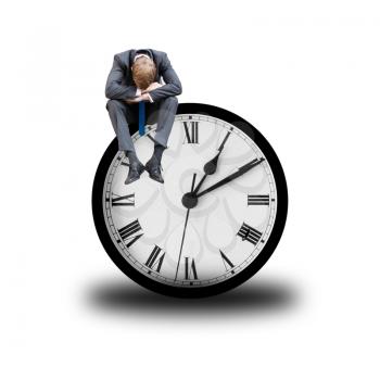 Tired businessman sitting on a clock