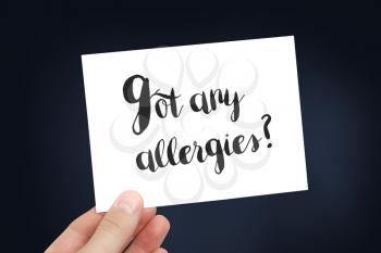 Allergies written on a white card