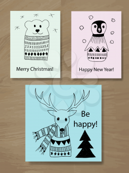 Vector Christmas Greeting Cards with Doodle Animals: reindeer, pinguin, and polar bear