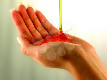 Royalty Free Photo of Gel Being Poured Into a Hand