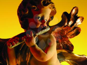 Royalty Free Photo of an Angel Figurine With a Flute