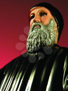 Royalty Free Photo of a Figurine of a Man in a Black Robe and Hat