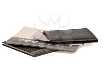 assorted notebooks with a cd flat piled on white background,sepia filter