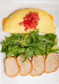 home made omelette with cheese tomato and rucola rocket salad arugola