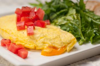 home made omelette with cheese tomato and rucola rocket salad arugola
