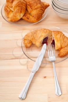 fresh baked croissant French brioche filled with berries jam