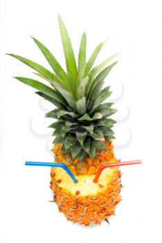 ripe pineapple cutted on top with red and blue straws isolated on white background