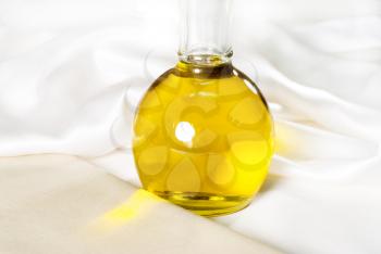italian exta virgin olive oil over a white silk background