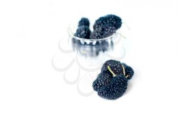 fresh ripe mulberry over white extreme closeup DOF glass bowl on background