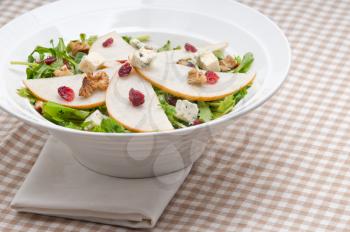 Fresh pears arugula gorgonzola cheese salad with cranberry and walnuts