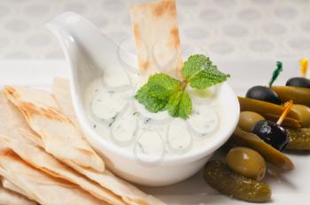 fresh Greek Tzatziki yogurt dip and pita bread and pickels