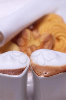 heart shaped espresso coffee cappuccino cups with assortment of pastry on background valentine day treat