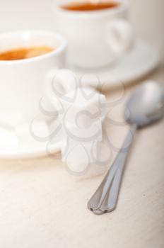 Italian espresso coffee fresh brewed macro closeup with sugar cubes
