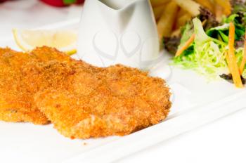 classic breaded Milanese veal cutlets with french fries and vegetables on background ,MORE DELICIOUS FOOD ON PORTFOLIO