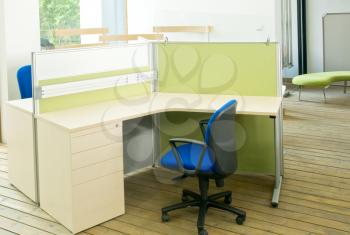 office desks and blue chairs cubicle set view from top over wood flooring 