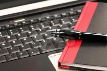 laptop keyboard and notebook with fountain pen