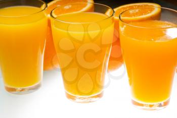 fresh and healthy orange juice ,unfiltered ,over a light table