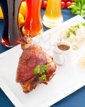 original German BBQ pork  knuckle served with mashed potatoes and  sauerkraut ,with selection of beers and fresh vegetables on background,MORE DELICIOUS FOOD ON PORTFOLIO