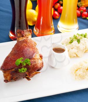 original German BBQ pork  knuckle served with mashed potatoes and  sauerkraut ,with selection of beers and fresh vegetables on background,MORE DELICIOUS FOOD ON PORTFOLIO