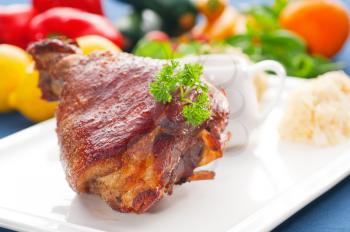 original German BBQ pork  knuckle served with mashed potatoes and  sauerkraut ,fresh vegetables on background,MORE DELICIOUS FOOD ON PORTFOLIO