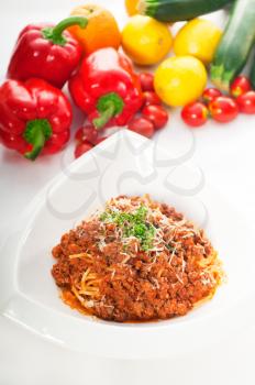 Italian classic  spaghetti with bolognese sauce and fresh vegetables on background,MORE DELICIOUS  FOOD ON PORTFOLIO