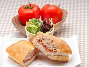 Italian ciabatta panini sandwich with parma ham and tomato