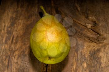autumn fresh pear over old wood board