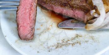 fresh juicy beef ribeye steak grilled,sliced on a plate