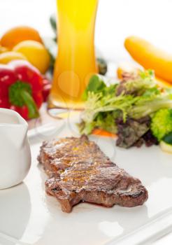 juicy BBQ grilled rib eye ,ribeye steak ,vegetables and lagher beer on background ,MORE DELICIOUS FOOD ON PORTFOLIO