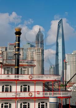 shanghai pudong view from puxi new bund with steam boat on huangpu river on foreground