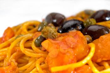 spaghetti italian pasta with fresh home made  puttanesca sauce,extreme closeup,macro