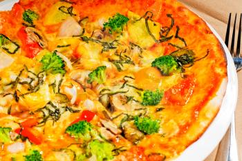 fresh italian thin style  vegetarian pizza with fresh mixed vegetables close up