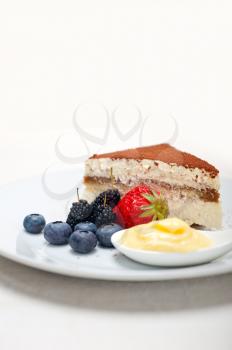 classic Italian tiramisu dessert with berries and custartd pastry cream on side 