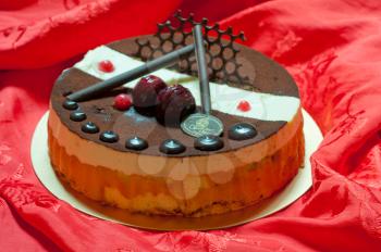 chocolate birthday cake over red fabric background